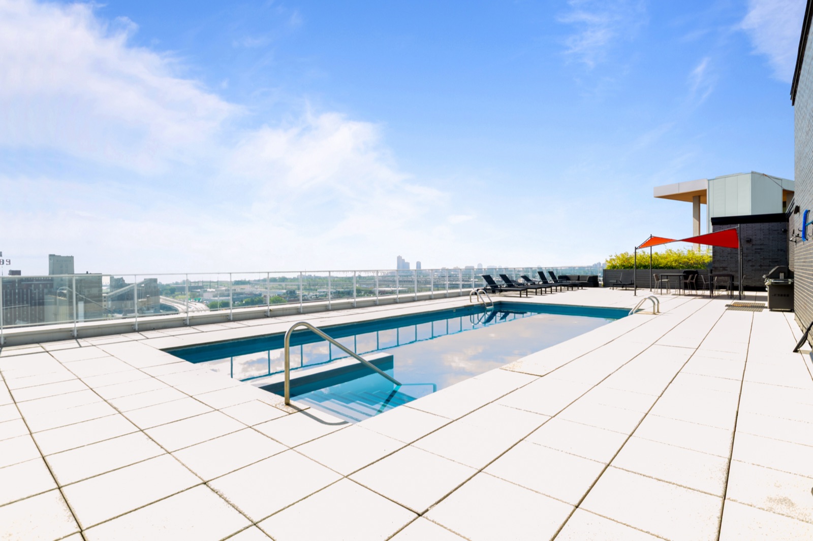 Aerial view of rooftop pool and city skyline
